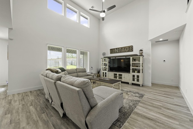 10009 Gray Jay Ct, Conroe, TX 77384 - living room featuring a high ceiling, a ceiling fan, and wood finished floors