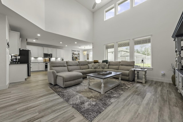 10009 Gray Jay Ct, Conroe, TX 77384 - living room featuring a ceiling fan, light wood-style flooring, a towering ceiling, and recessed lighting