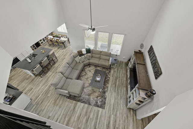 10009 Gray Jay Ct, Conroe, TX 77384 - living area with wood finished floors, a high ceiling, and a ceiling fan