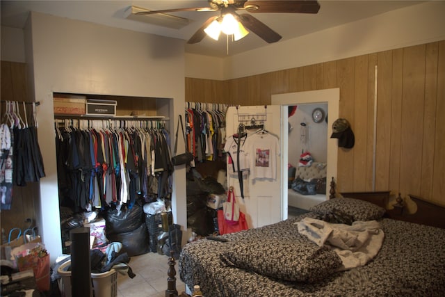 622 S Hackberry St, San Antonio, TX 78203 - tiled bedroom with a closet, a ceiling fan, and wooden walls