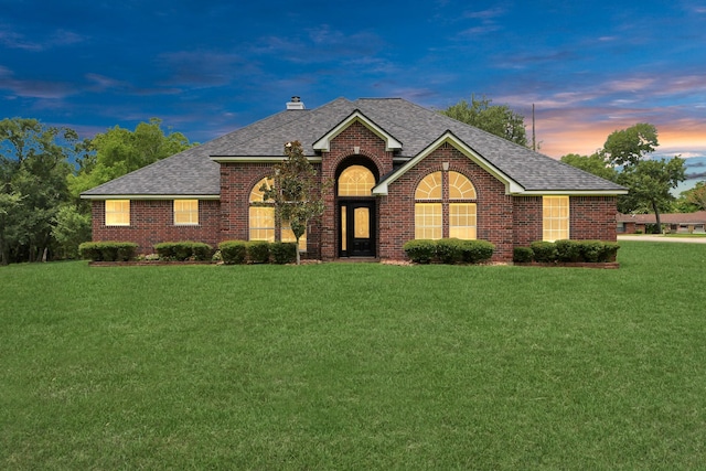 5874 Natchez Trce, Baytown, TX 77523 - view of front of property featuring a shingled roof, brick siding, a yard, and a chimney