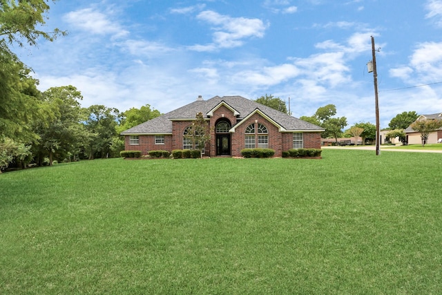 5874 Natchez Trce, Baytown, TX 77523 - view of front of property featuring brick siding, a front yard, a shingled roof, and a chimney