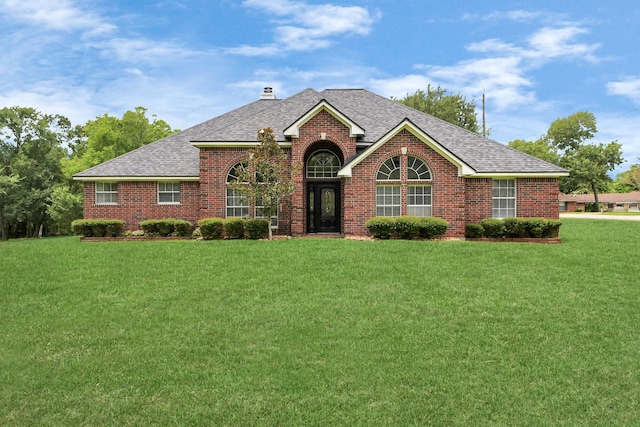 5874 Natchez Trce, Baytown, TX 77523 - view of front of home with brick siding, roof with shingles, and a front yard