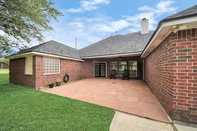 5874 Natchez Trce, Baytown, TX 77523 - back of property with roof with shingles, brick siding, a patio, a chimney, and a lawn
