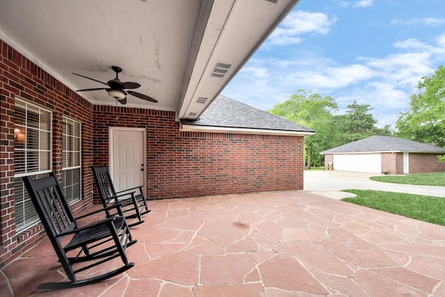 5874 Natchez Trce, Baytown, TX 77523 - view of patio featuring ceiling fan, a garage, an outbuilding, and concrete driveway