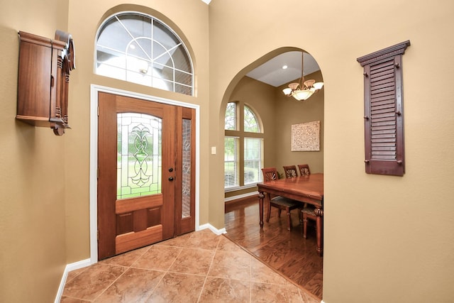 5874 Natchez Trce, Baytown, TX 77523 - entryway with light tile patterned floors, arched walkways, and a high ceiling