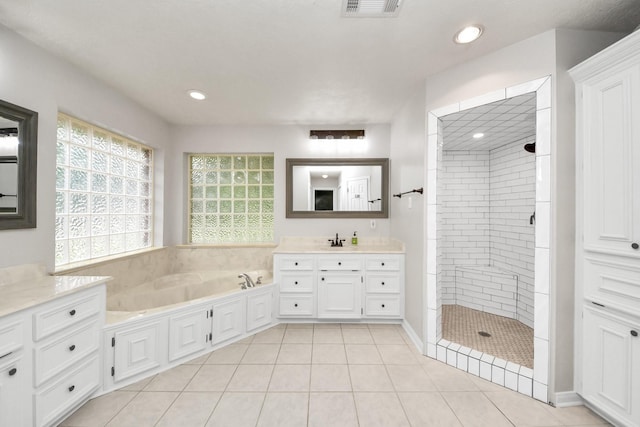 5874 Natchez Trce, Baytown, TX 77523 - bathroom with vanity, a shower stall, a bath, tile patterned flooring, and recessed lighting