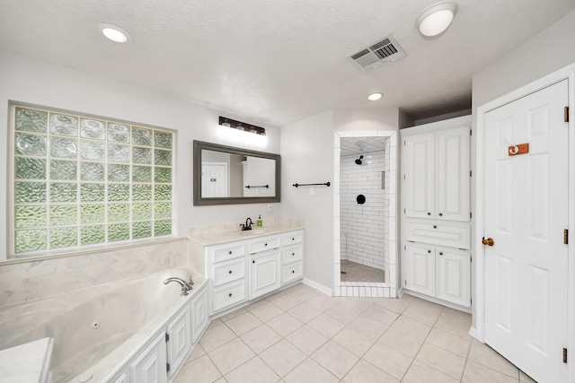 5874 Natchez Trce, Baytown, TX 77523 - bathroom featuring vanity, tiled shower, a tub with jets, tile patterned flooring, and recessed lighting