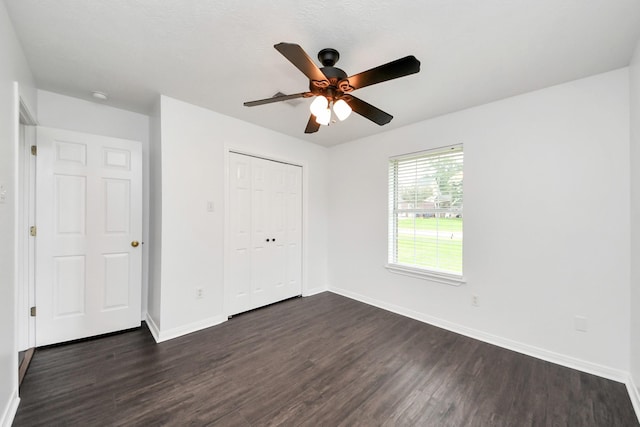 5874 Natchez Trce, Baytown, TX 77523 - unfurnished bedroom with dark wood-style floors, a closet, and a ceiling fan