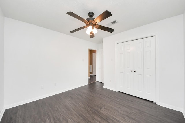 5874 Natchez Trce, Baytown, TX 77523 - unfurnished bedroom with dark wood-style flooring, a closet, and a ceiling fan