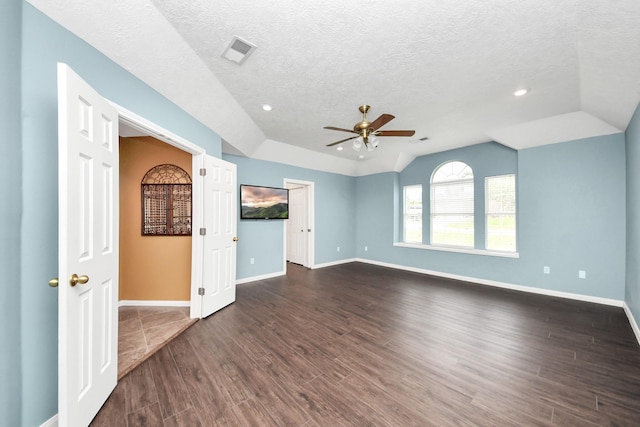 5874 Natchez Trce, Baytown, TX 77523 - unfurnished living room featuring dark wood-type flooring, ceiling fan, vaulted ceiling, a textured ceiling, and recessed lighting