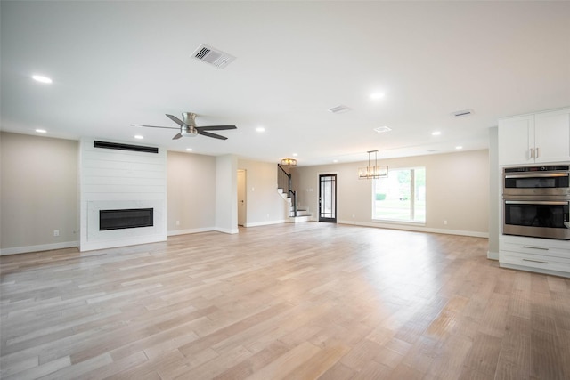 7710 Meadowvale Dr, Houston, TX 77063 - unfurnished living room featuring a fireplace, a ceiling fan, light wood-style flooring, recessed lighting, and stairs