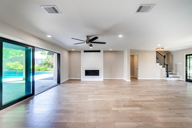 7710 Meadowvale Dr, Houston, TX 77063 - unfurnished living room with recessed lighting, a ceiling fan, stairs, light wood-style flooring, and a premium fireplace