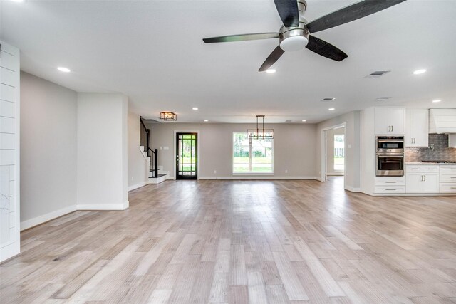 7710 Meadowvale Dr, Houston, TX 77063 - unfurnished living room with recessed lighting, light wood-type flooring, ceiling fan, and stairway