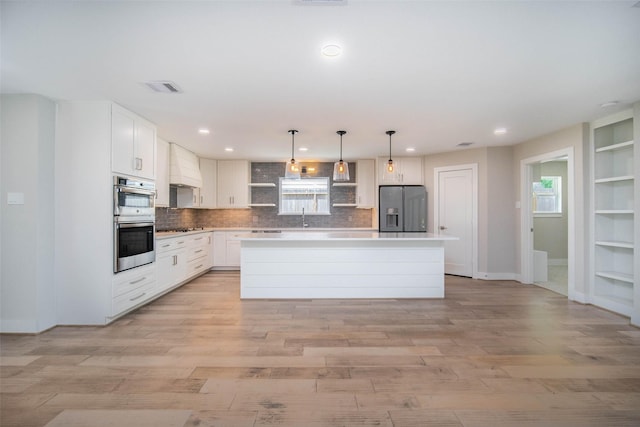 7710 Meadowvale Dr, Houston, TX 77063 - kitchen with fridge with ice dispenser, a kitchen island, tasteful backsplash, plenty of natural light, and recessed lighting