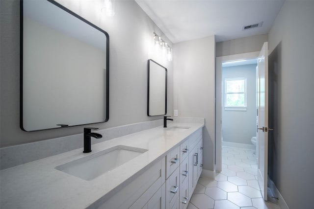 7710 Meadowvale Dr, Houston, TX 77063 - bathroom with double vanity and tile patterned flooring