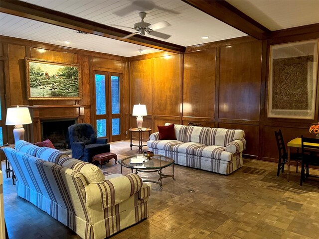 5610 Woodway Dr, Houston, TX 77056 - living room featuring beam ceiling, wooden walls, a ceiling fan, a fireplace, and a decorative wall