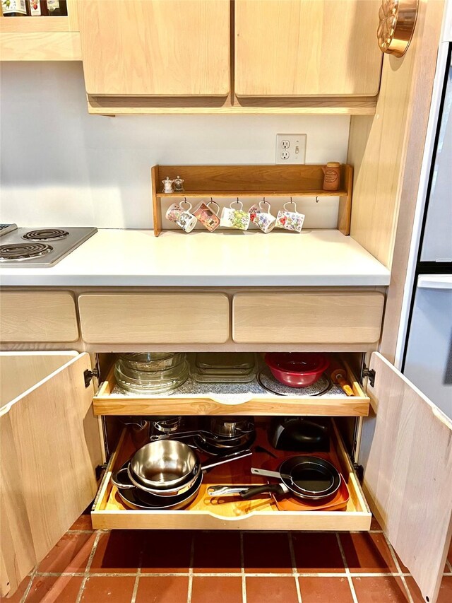 5610 Woodway Dr, Houston, TX 77056 - kitchen view of stainless steel electric cooktop, light countertops, and light brown cabinetry
