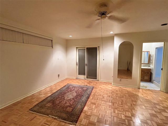 5610 Woodway Dr, Houston, TX 77056 - unfurnished bedroom featuring arched walkways, recessed lighting, connected bathroom, and ceiling fan