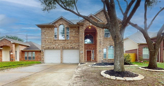 19943 Silver Rock Dr, Katy, TX 77449 - traditional-style house with brick siding, an attached garage, and concrete driveway