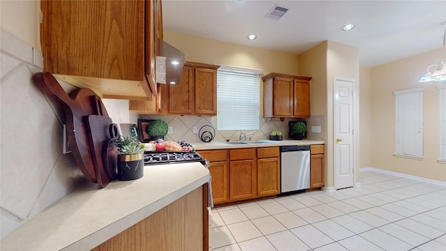 19943 Silver Rock Dr, Katy, TX 77449 - kitchen with stainless steel dishwasher, light countertops, tasteful backsplash, brown cabinets, and recessed lighting
