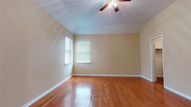 19943 Silver Rock Dr, Katy, TX 77449 - unfurnished bedroom featuring light wood-style flooring, a spacious closet, a ceiling fan, and vaulted ceiling