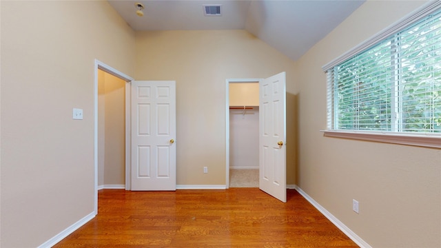 19943 Silver Rock Dr, Katy, TX 77449 - unfurnished bedroom featuring wood finished floors, a closet, vaulted ceiling, and a spacious closet