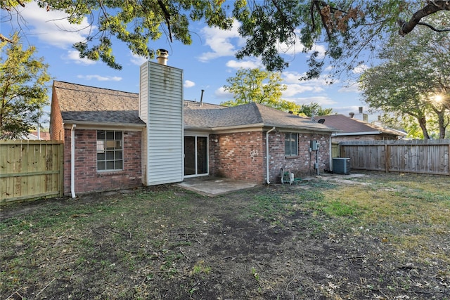 20062 S Pecos Valley Trl, Katy, TX 77449 - back of property featuring brick siding, a chimney, a fenced backyard, and a shingled roof