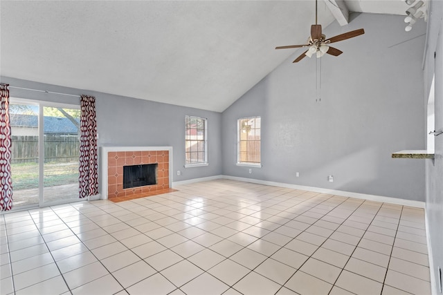 20062 S Pecos Valley Trl, Katy, TX 77449 - unfurnished living room with high vaulted ceiling, beamed ceiling, a ceiling fan, light tile patterned flooring, and a tile fireplace