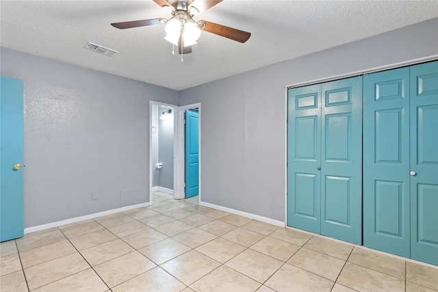 20062 S Pecos Valley Trl, Katy, TX 77449 - unfurnished bedroom with a textured ceiling, light tile patterned floors, a closet, and a ceiling fan
