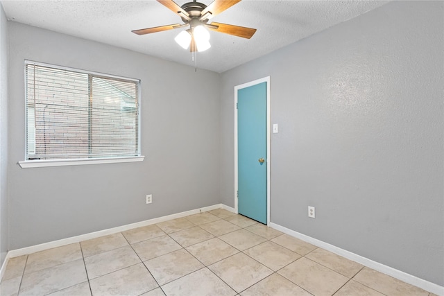20062 S Pecos Valley Trl, Katy, TX 77449 - empty room featuring a textured ceiling, ceiling fan, and light tile patterned flooring