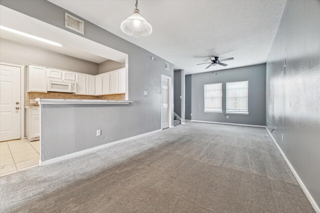 4340 Phlox St A/B, Unit A/B Houston, TX 77051 - unfurnished living room featuring light carpet, ceiling fan, and stairway