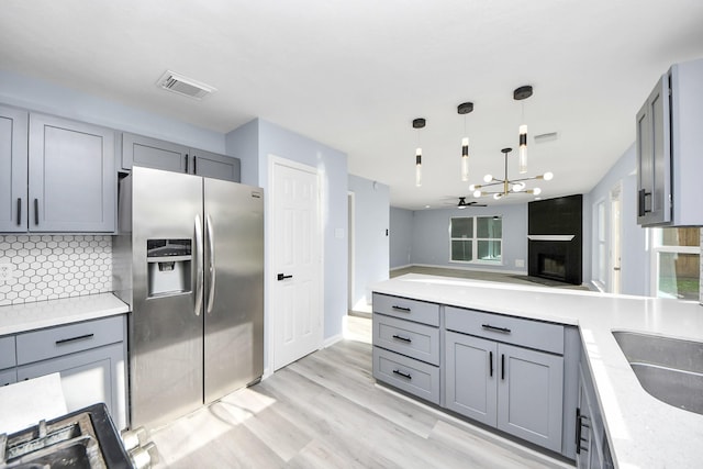 4211 Royal Manor Dr, Pasadena, TX 77505 - kitchen featuring stainless steel refrigerator with ice dispenser, gray cabinets, and backsplash