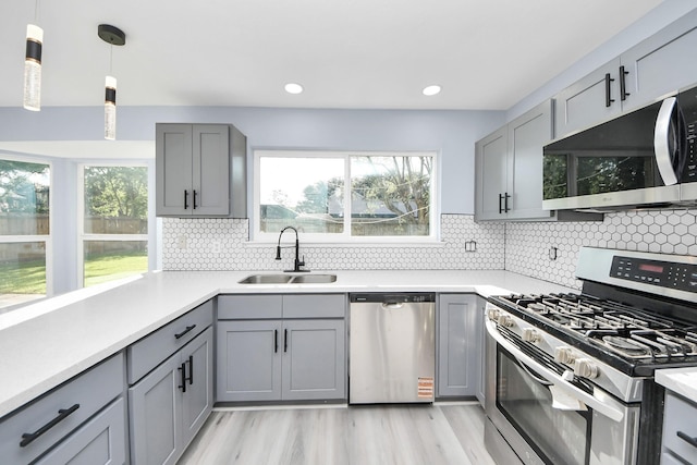 4211 Royal Manor Dr, Pasadena, TX 77505 - kitchen with appliances with stainless steel finishes, gray cabinetry, light wood finished floors, light countertops, and recessed lighting