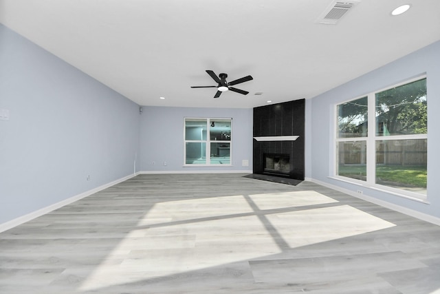4211 Royal Manor Dr, Pasadena, TX 77505 - unfurnished living room featuring wood finished floors, a fireplace, a ceiling fan, and recessed lighting