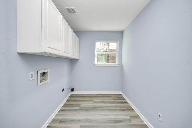 4211 Royal Manor Dr, Pasadena, TX 77505 - laundry area with cabinet space, hookup for a washing machine, light wood-type flooring, and gas dryer hookup