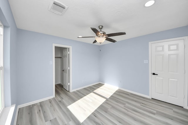 4211 Royal Manor Dr, Pasadena, TX 77505 - unfurnished bedroom featuring light wood-type flooring, ceiling fan, recessed lighting, a spacious closet, and a closet