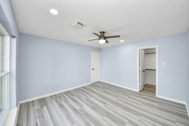 4211 Royal Manor Dr, Pasadena, TX 77505 - unfurnished bedroom with light wood finished floors, ceiling fan, recessed lighting, a walk in closet, and a closet