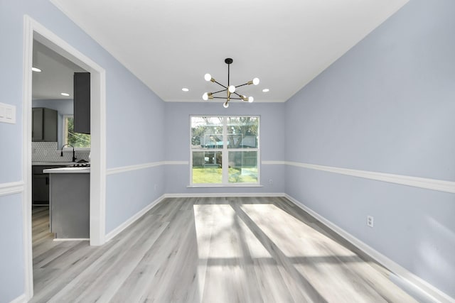 4211 Royal Manor Dr, Pasadena, TX 77505 - spare room with a chandelier, light wood-style flooring, and recessed lighting