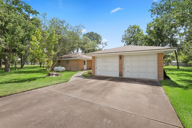 13329 24th St, Santa Fe, TX 77510 - view of front of house with a detached garage, a front lawn, and brick siding