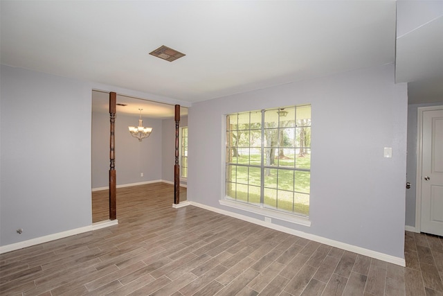 13329 24th St, Santa Fe, TX 77510 - spare room with a chandelier and wood finished floors