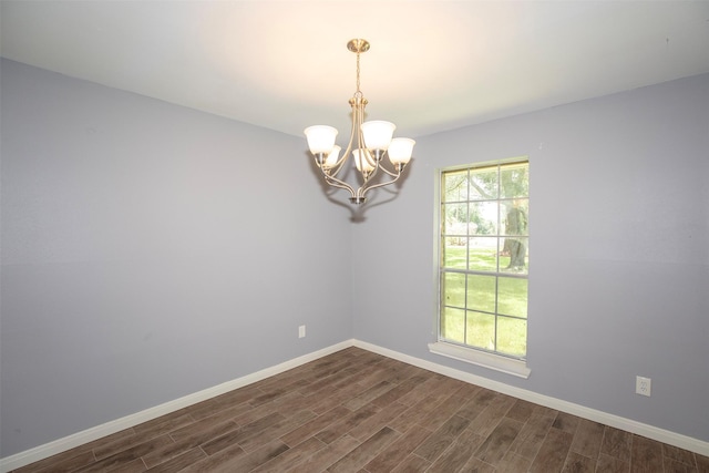 13329 24th St, Santa Fe, TX 77510 - spare room with dark wood-type flooring and a chandelier