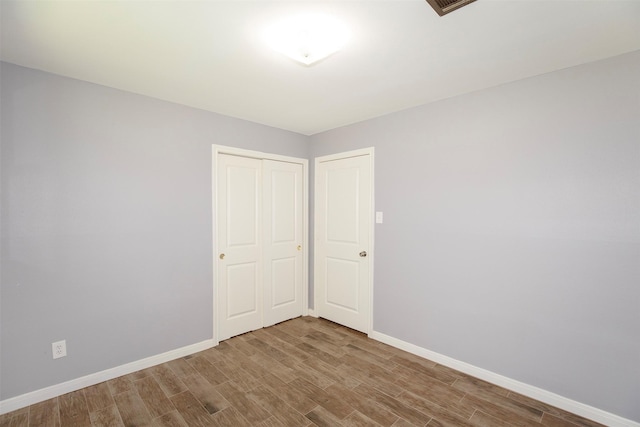 13329 24th St, Santa Fe, TX 77510 - unfurnished bedroom featuring wood finished floors and a closet