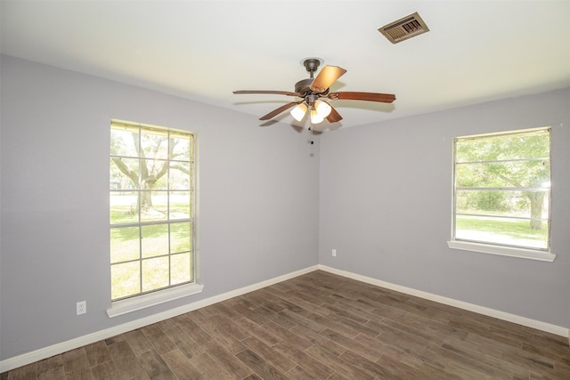 13329 24th St, Santa Fe, TX 77510 - unfurnished room featuring a ceiling fan, healthy amount of natural light, and dark wood-style floors