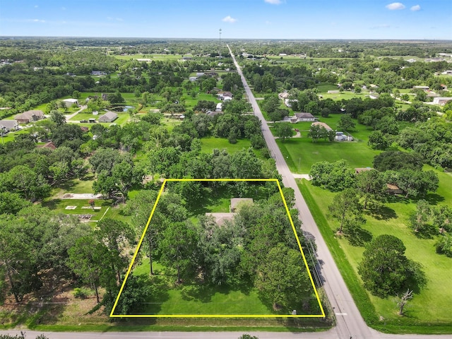 13329 24th St, Santa Fe, TX 77510 - aerial overview of property's location with property parcel outlined and a tree filled landscape