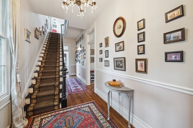 607 11th St, Galveston, TX 77550 - foyer entrance featuring a chandelier, wood finished floors, stairway, and healthy amount of natural light