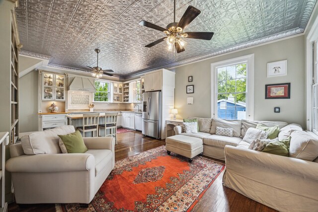607 11th St, Galveston, TX 77550 - living room featuring an ornate ceiling, ornamental molding, dark wood-style floors, and a ceiling fan