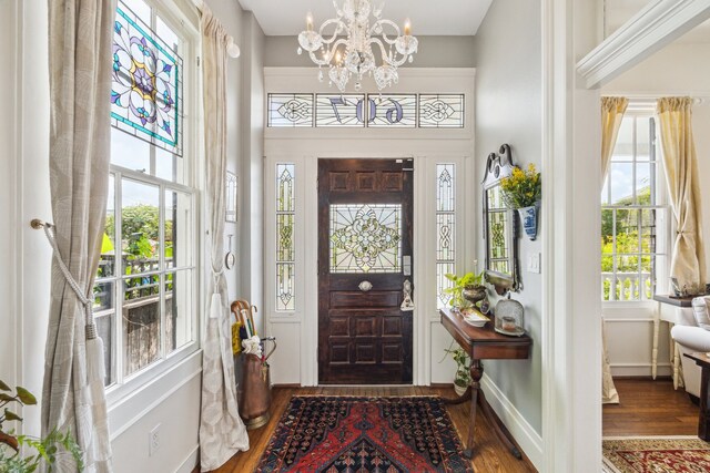 607 11th St, Galveston, TX 77550 - entrance foyer with wood finished floors, a chandelier, and a high ceiling
