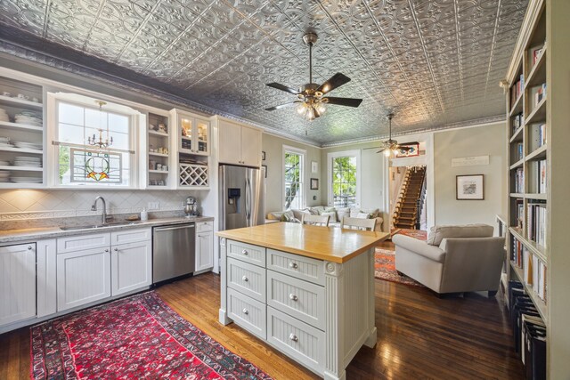 607 11th St, Galveston, TX 77550 - kitchen with stainless steel appliances, an ornate ceiling, wooden counters, open shelves, and dark wood-style flooring