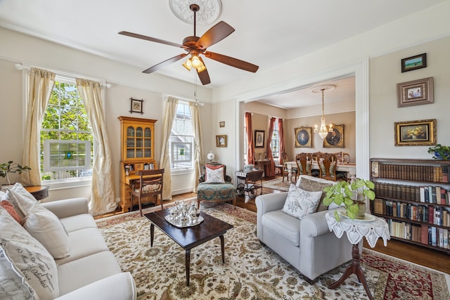 607 11th St, Galveston, TX 77550 - living area with wood finished floors, ceiling fan, and a chandelier